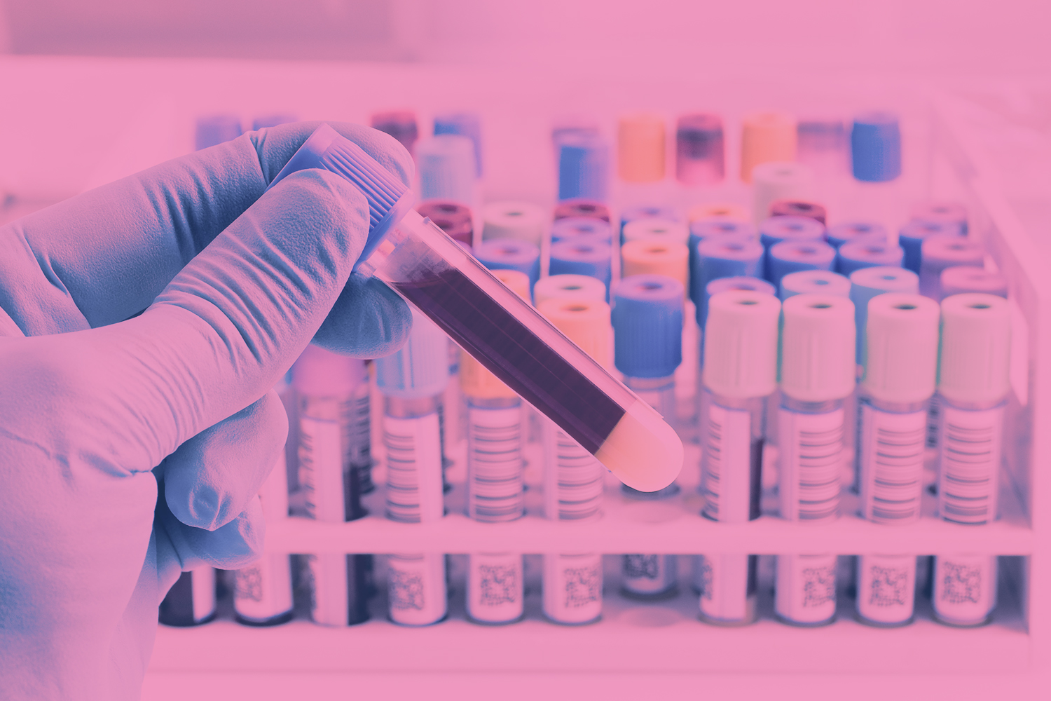 une main gantée tenant un tube d'analyse